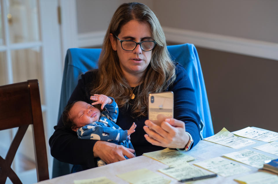 STAMFORD, CONNECTICUT - MAY 1: Elementary school teacher Luciana Lira, 42, speaks with a student remotely via video call while caring for one-month-old Neysel at her home on May 1, 2020 in Stamford, Connecticut. Lira, a K-5 Bilingual /ESL teacher at Hart Magnet Elementary in Stamford, became Neysel's temporary guardian after the boy's mother Zully, almost 8 months pregnant, went to the Stamford Hospital emergency room, gravely ill with COVID-19 and gave birth. Hospital staff performed an emergency C-section to save the child and Zully was put on a ventilator. Baby Neysel could not go home, as his father Marvin and brother Junior were COVID-19 positive and quarantined there. After several weeks in the hospital, Zully responded well to antibody blood plasma transfusions and was able to return home. The teacher Lira will continue caring for the baby until the infant's parents and brother test COVID-negative, and the Guatemalan immigrant family can all be reunited. (Photo by John Moore/Getty Images)