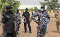 Security forces guard the Government Girls Junior Secondary School where more than 300 girls were abducted by gunmen on Friday, in Jangebe town, Zamfara state, northern Nigeria Sunday, Feb. 28, 2021. Families in Nigeria waited anxiously on Sunday for news of their abducted daughters, the latest in a series of mass kidnappings of school students in the West African nation. (AP Photo/Ibrahim Mansur)