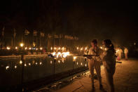 Israeli scouts light torches during a Memorial Day ceremony commemorating fallen soldiers, at the military cemetery at Mount Herzl in Jerusalem, Tuesday, April 13, 2021. (AP Photo/Maya Alleruzzo)