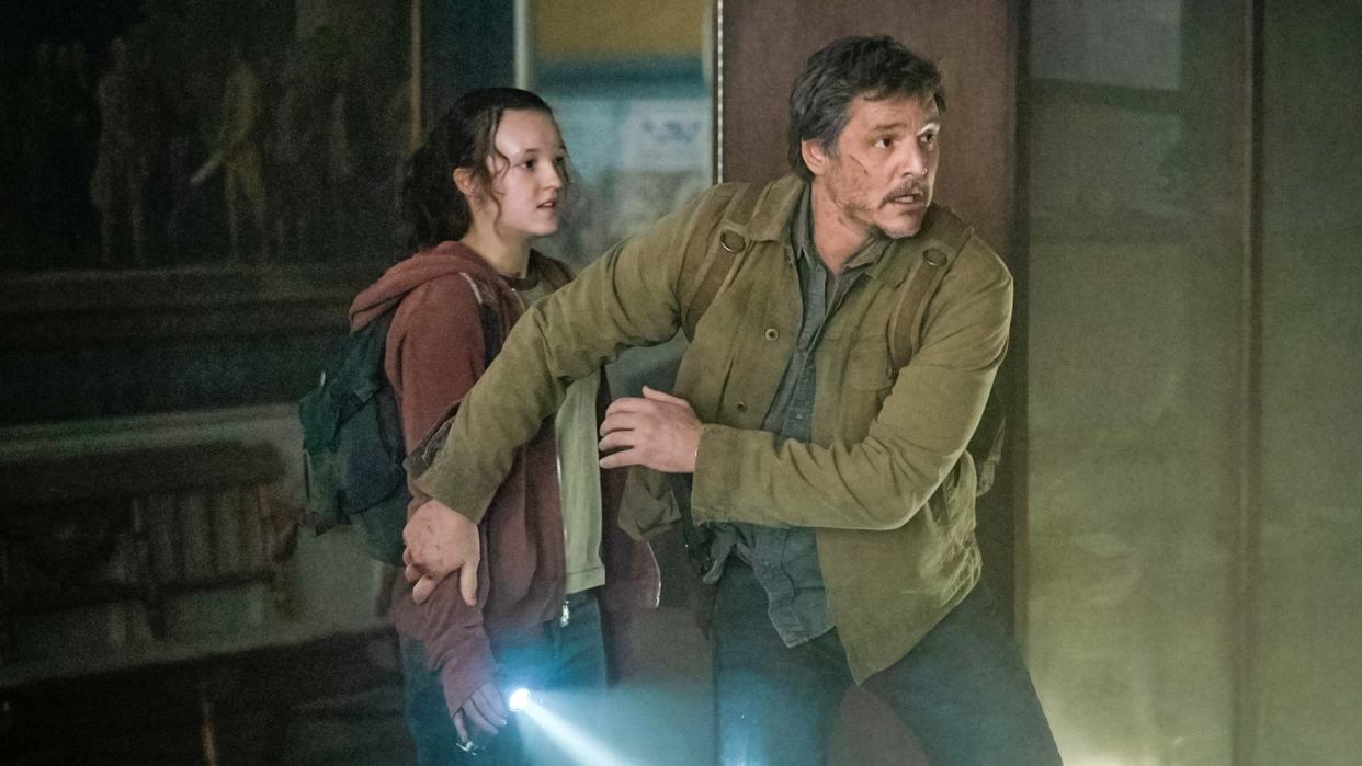  (L to R) Bella Ramsey as Ellie and Pedro Pascal as Joel, navigating a museum, in The Last of Us on HBO. 