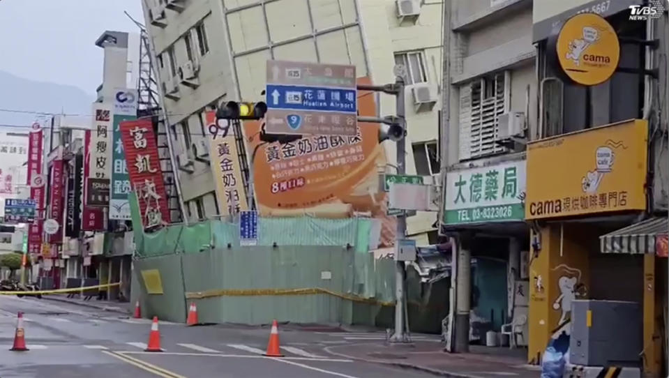 In this image from a video, roads in Hualien, Taiwan are cordoned off after a cluster of earthquakes struck the island early Tuesday, April 23, 2024. There were no reports of casualties in the quakes, although there were further damages to two multi-story buildings that had been evacuated following a magnitude 7.4 quake that hit the island earlier this month, killing 13 people and injuring over 1,000. (TVBS via AP)