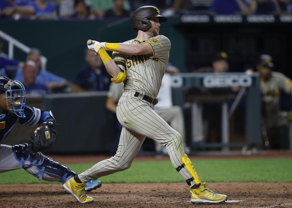 San Diego Padres' Jake Cronenworth follows through on an RBI single during the seventh inning of baseball game against the Kansas City Royals in Kansas City, Mo., Friday, Aug. 26, 2022. (AP Photo/Colin E. Braley)
