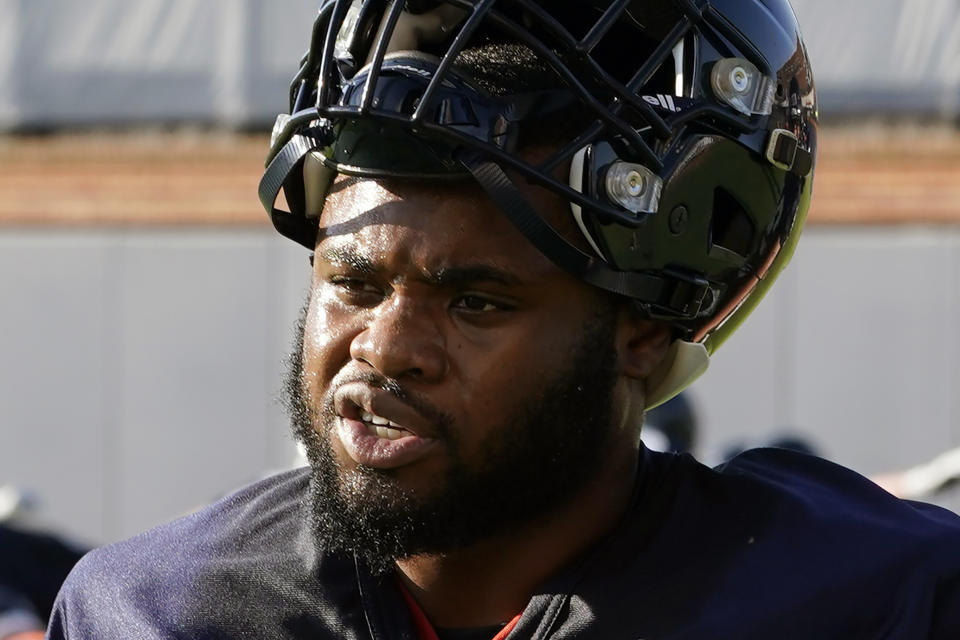 FILE - Virginia running back Mike Hollins takes a break during NCAA college football practice Wednesday Aug. 3, 2022, in Charlottesville, Va. Hollins, who survived a shooting that left three of his teammates dead and returned to the Cavaliers less than a year later, is one of three recipients of college football’s Comeback Player of the Year Award, announced Monday, Dec. 18, 2023. (AP Photo/Steve Helber, File)