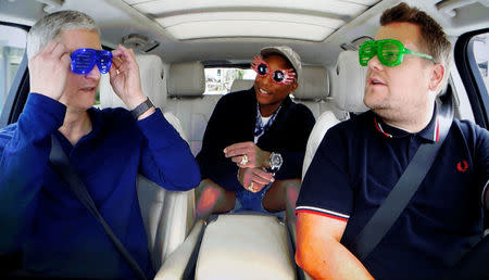 FILE PHOTO - Apple Inc CEO Tim Cook is shown with TV personality James Corden and musician Pharrell during a taped comedy bit in this image shot from a projection screen during an Apple media event in San Francisco, California, U.S. on September 7, 2016. REUTERS/Beck Diefenbach/File Photo