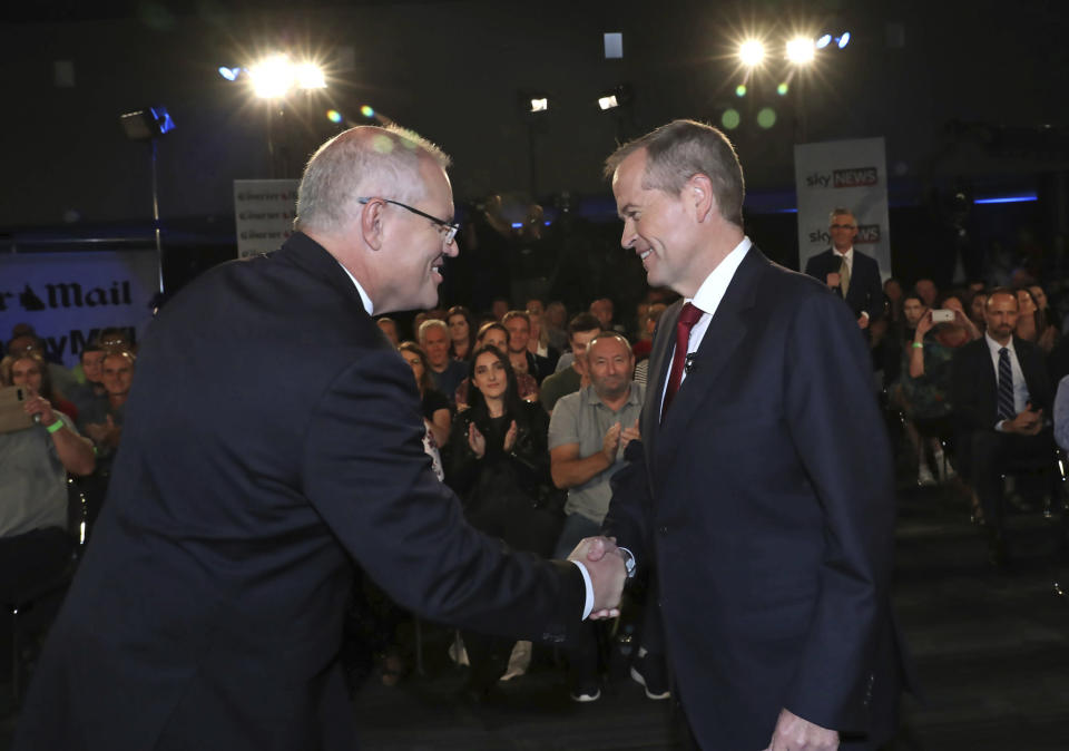 Australian Prime Minister Scott Morrison, left, and opposition leader Bill Shorten shake hands before the Sky News/Courier Mail People's Forum in Brisbane, May 3, 2019. Scandals surrounding candidates have become distractions for Morrison and Shorten this week as they attempt to focus voters on policies ahead of the May 18 election. (Gary Ramage/Pool via AP)