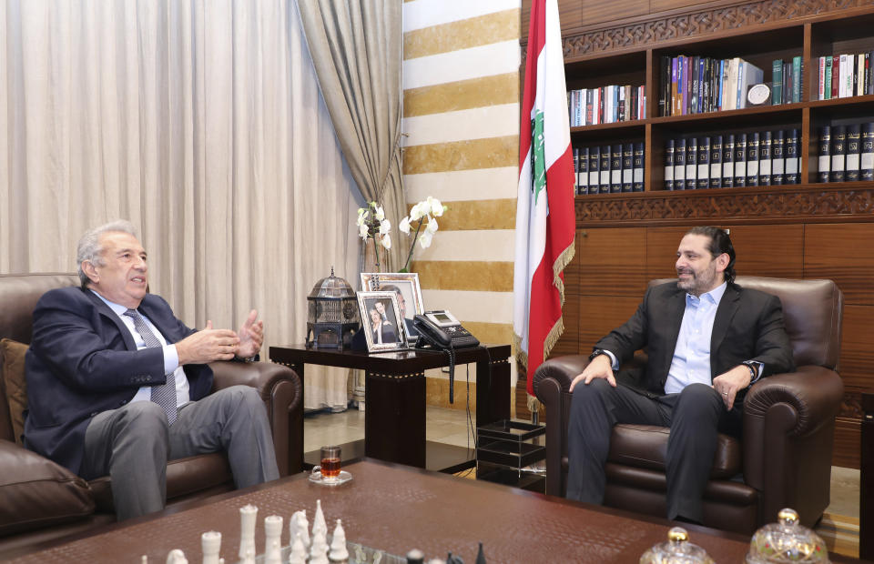 In this photo released by the Lebanese Government, Lebanon's outgoing Prime Minister Saad Hariri, right, meets with Samir Khatib, the head of a major contracting and construction and once considered a favorite candidate for the post of Prime Minister, in Beirut, Lebanon, Sunday, Dec. 8, 2019. (Dalati Nohra via AP)