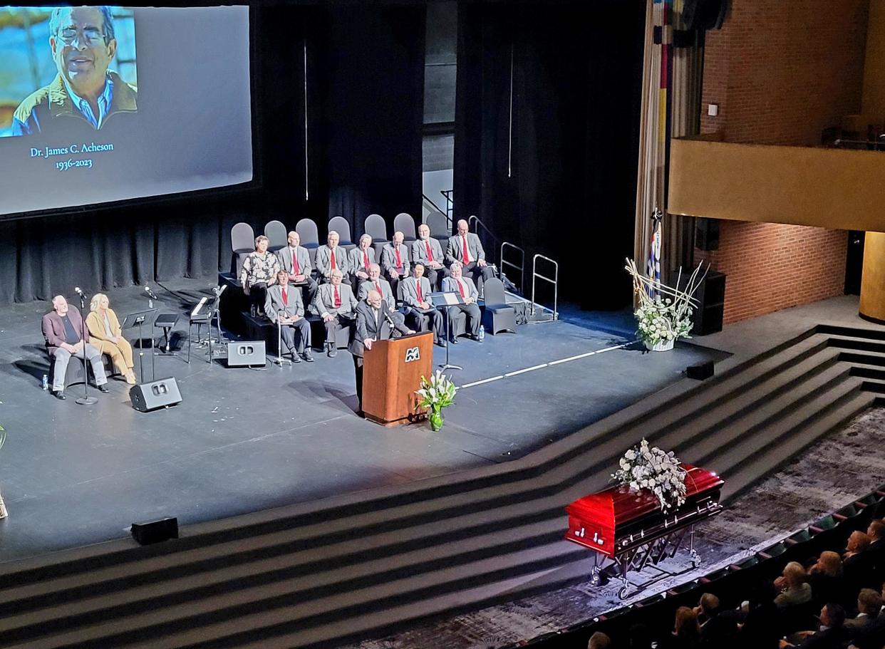 Frank Tranzow, a decades-long friend of Jim Acheson, speaks during his funeral on Wednesday, April 12, 2023, at McMorran Theater.