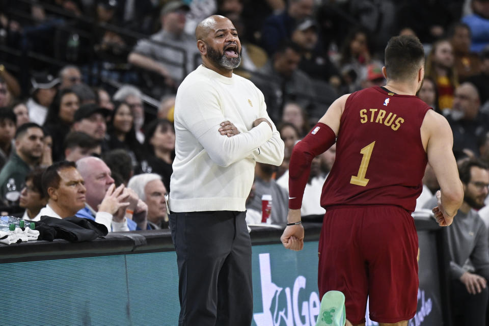 Cleveland Cavaliers head coach J.B. Bickerstaff, left, yells to his players during the first half of an NBA basketball game against the San Antonio Spurs, Saturday, Feb. 3, 2024, in San Antonio. (AP Photo/Darren Abate)