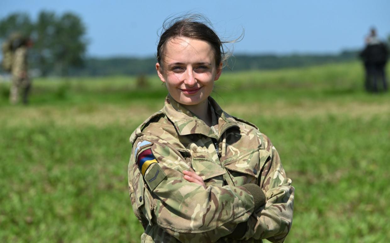 Lance Corporal Addy Carter, the first female to pass the Parachute Regiment's P Company course, poses after taking part in a parachute jump