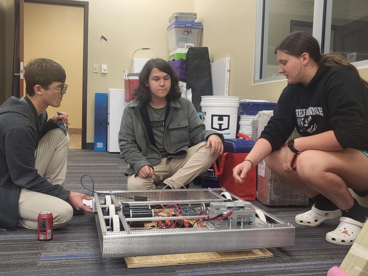 Members of the Bayou Crusaders robotic team work on their creation, February 29. From left to right, Brayden Durocher, 13; Noah Smith, 16; and Anabelle Barnett, 14.