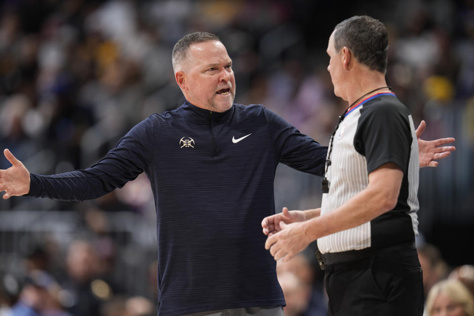 Denver Nuggets head coach Michael Malone, left, argues with referee Matt Boland in the second half of an NBA basketball game against the Los Angeles Lakers, Monday, Jan. 9, 2023, in Denver. (AP Photo/David Zalubowski)