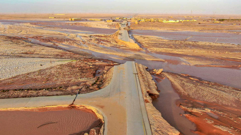 View of floodwater covering a large area of open land.