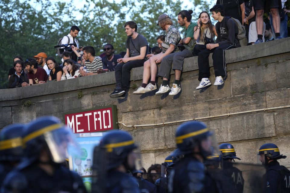 Police patrol as youths gather on Concorde square during a protest in Paris, France, Friday, June 30, 2023. French President Emmanuel Macron urged parents Friday to keep teenagers at home and proposed restrictions on social media to quell rioting spreading across France over the fatal police shooting of a 17-year-old driver. (AP Photo/Lewis Joly)