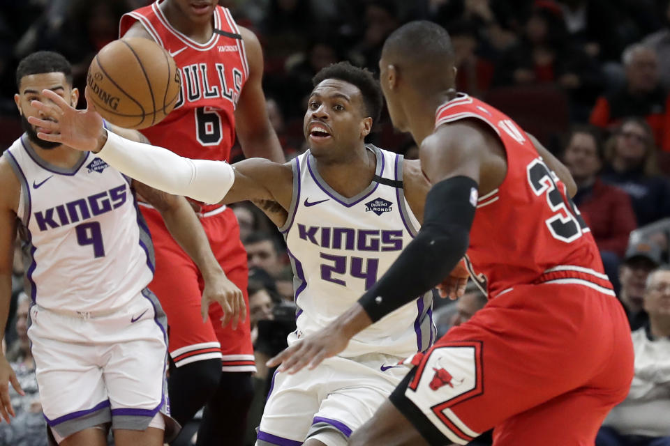 Sacramento Kings guard Buddy Hield, left, controls the ball against Chicago Bulls guard Kris Dunn during the first half of an NBA basketball game in Chicago, Friday, Jan. 24, 2020. (AP Photo/Nam Y. Huh)