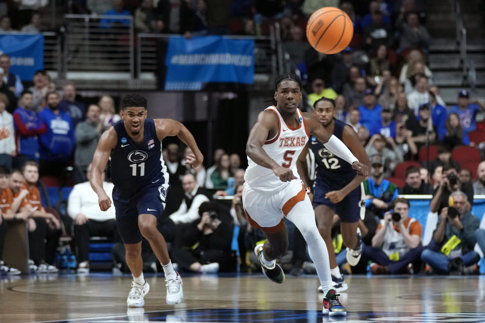 Texas guard Marcus Carr (5) scrambles for a loose ball with Penn State guard Camren Wynter (11) in the second half of a second-round college basketball game in the NCAA Tournament, Saturday, March 18, 2023, in Des Moines, Iowa. (AP Photo/Charlie Neibergall)