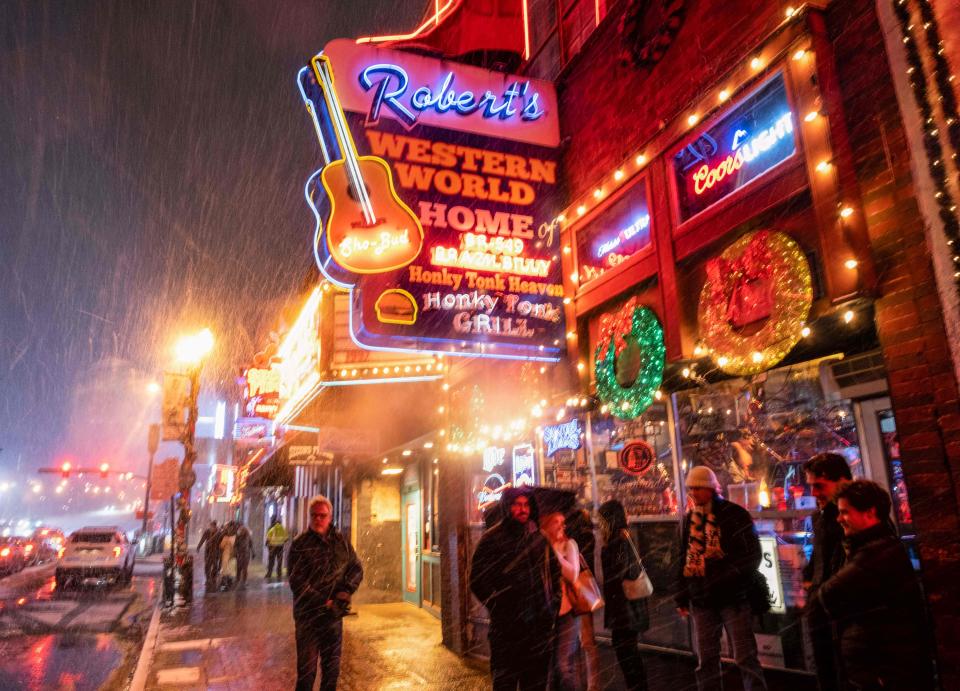 Snow falls on Broadway, a popular spot in “Music City” Nashville, Tennessee, on December 22, 2022. A 