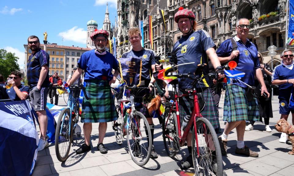 <span>Supporter Ethan Walker (centre) cycled 1,200km to watch Scotland play in Germany.</span><span>Photograph: Bradley Collyer/PA</span>