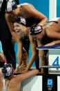 ATHENS - AUGUST 18: Natalie Coughlin, Carly Piper, Dana Vollmer and Kaitlin Sandeno of USA celebrates after the USA won the women's swimming 4 x 200 metre freestyle relay final with a world record time of 7:53.42 on August 18, 2004 during the Athens 2004 Summer Olympic Games at the Main Pool of the Olympic Sports Complex Aquatic Centre in Athens, Greece. (Photo by Chris McGrath/Getty Images)