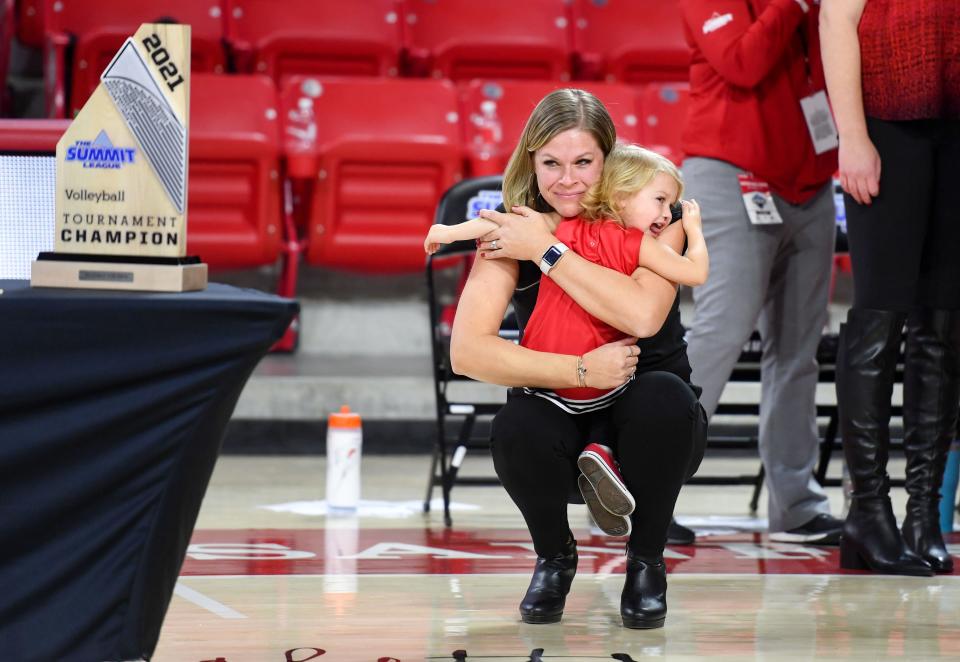 South Dakota volleyball head coach Leanne Williamson holds back tears as she hugs her daughter after the team's 3-0 win over Omaha in the Summit League Tournament championship match on Saturday, November 27, 2021, at the Sanford Coyote Sports Center in Vermillion. The Coyotes' secures them a spot in the NCAA tournament.