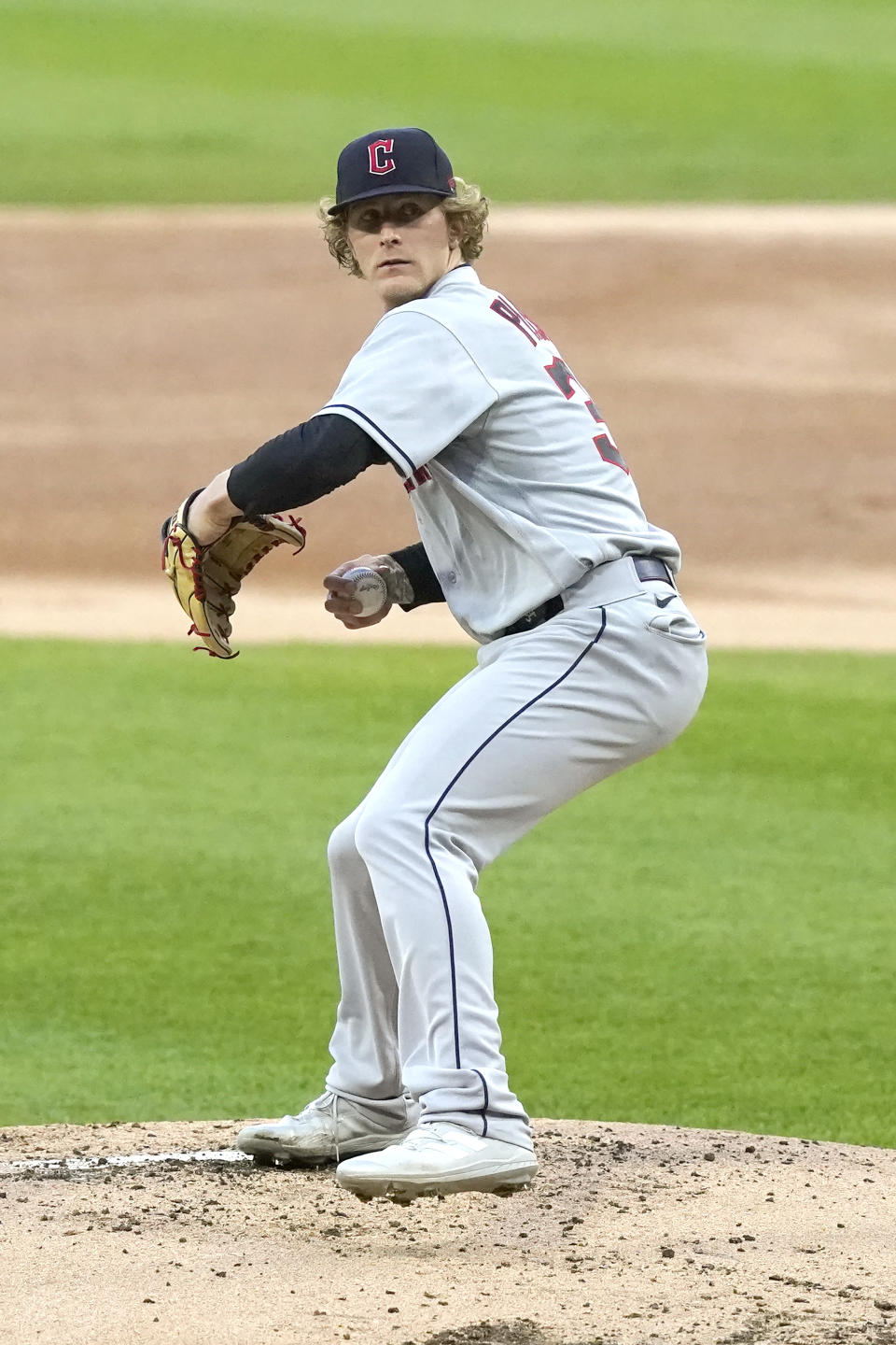 Cleveland Guardians starting pitcher Zach Plesac winds up during the first inning of a baseball game against the Chicago White Sox Monday, May 9, 2022, in Chicago. (AP Photo/Charles Rex Arbogast)