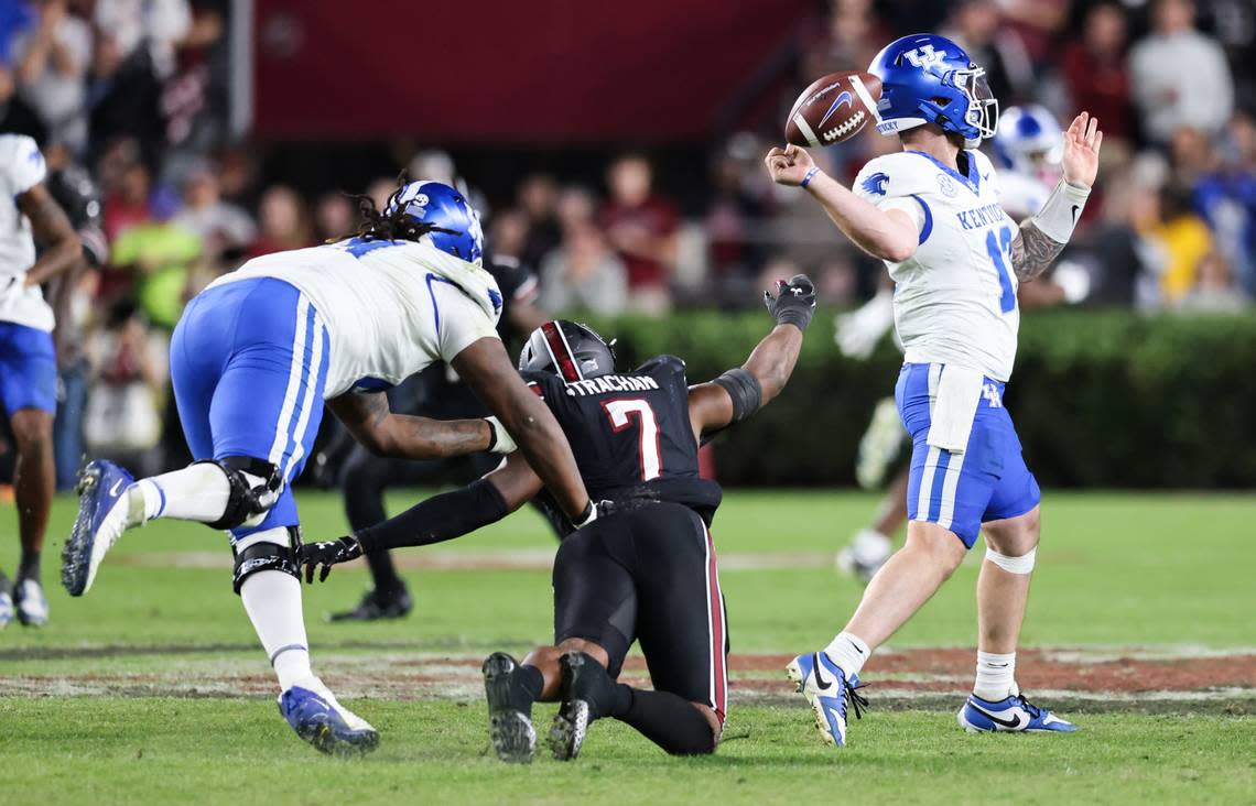 Kentucky quarterback Devin Leary (13) loses the ball as South Carolina defensive end Jordan Strachan (7) pressures him from behind during the second half of the Gamecocks’ game at Williams-Brice Stadium in Columbia on Saturday, November 18, 2023.