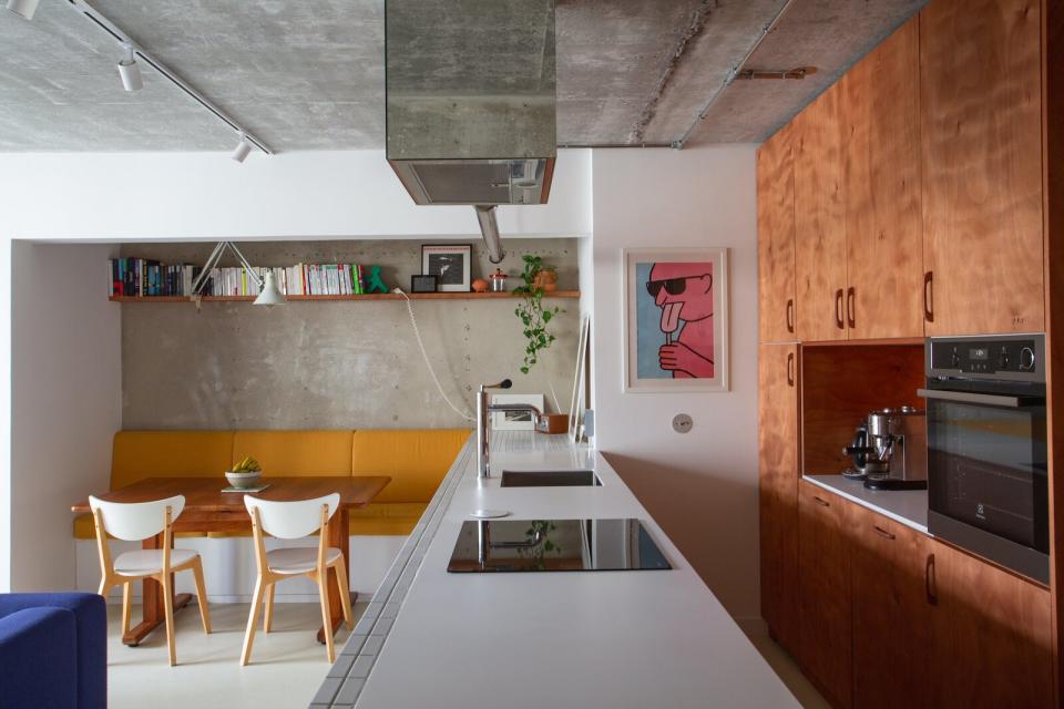 The yellow upholstery of the banquette seating in the dining nook was inspired by the couple’s recent visit to Neutra VDL Studio and Residences in Los Angeles.