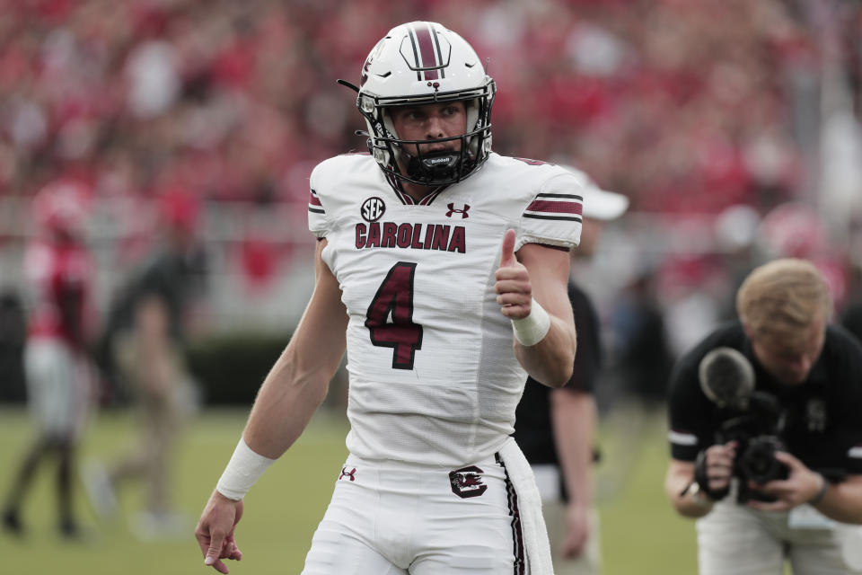 South Carolina quarterback Luke Doty (4) gestures to teammates before the team's NCAA college football game against Georgia on Saturday, Sept. 18, 2021, in Athens, Ga. (Joshua Boucher/The State via AP)