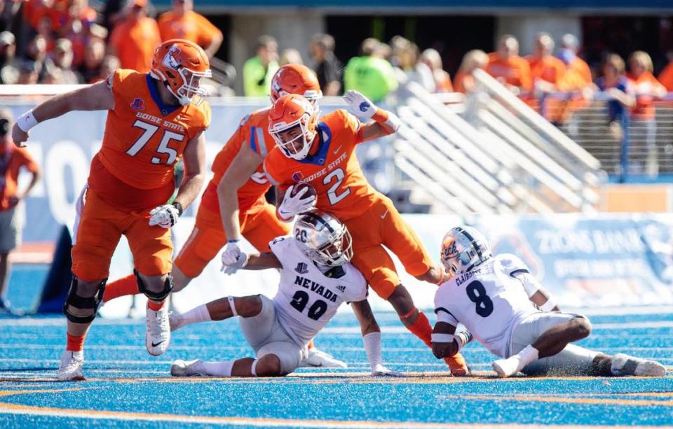 Boise State wide receiver Khalil Shakir gets stuck as he carries the ball during their game against Nevada on Saturday at Albertsons Stadium.