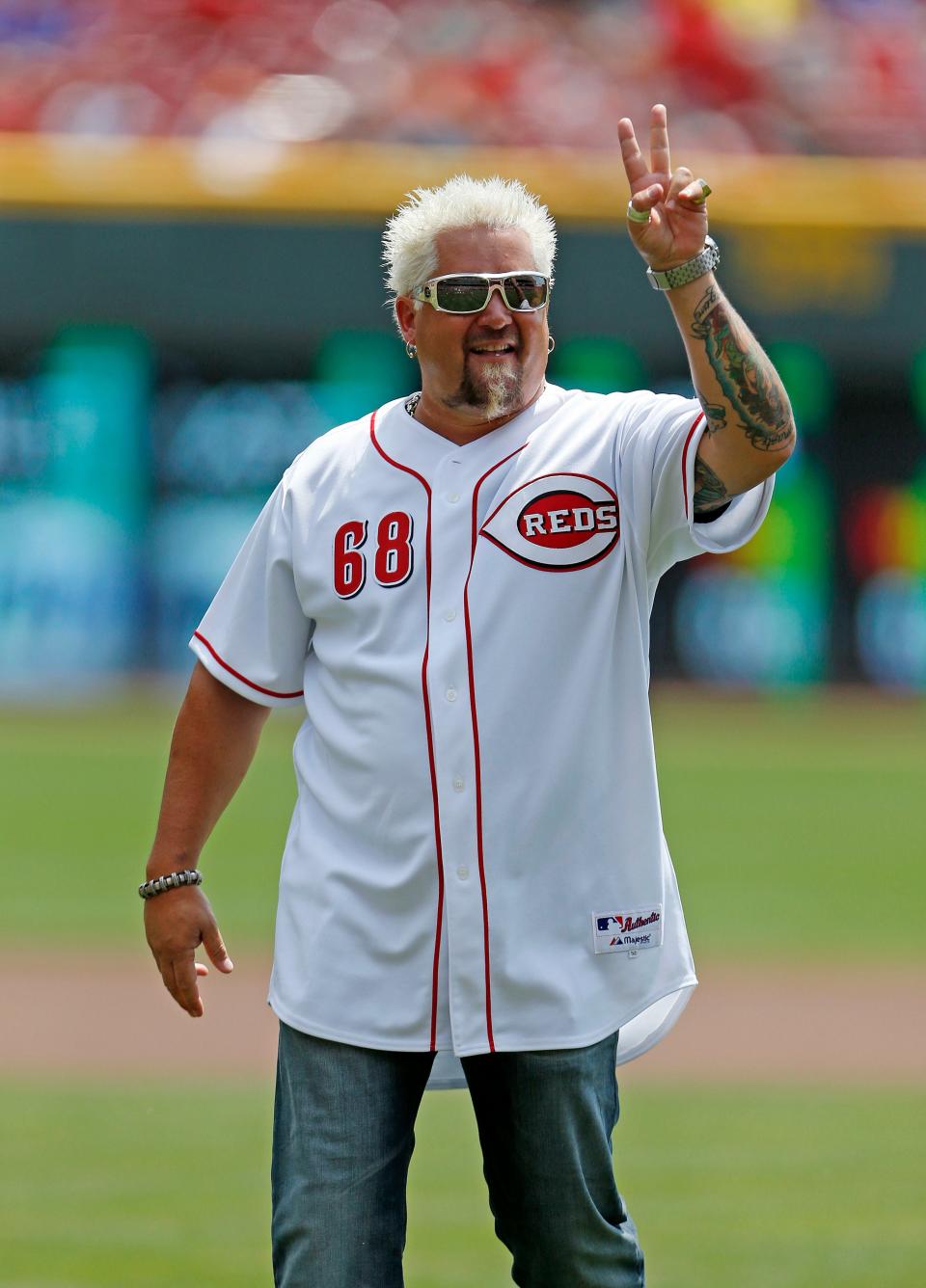 Guy Fieri, who was born in Columbus, Ohio, throws out the first pitch at Great American Ball Park in Cincinnati before the Cincinnati Reds-Chicago Cubs baseball game in 2014.