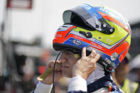 Alex Palou, of Spain, puts on his helmet during practice for the Indianapolis 500 auto race at Indianapolis Motor Speedway, Thursday, May 19, 2022, in Indianapolis. (AP Photo/Darron Cummings)