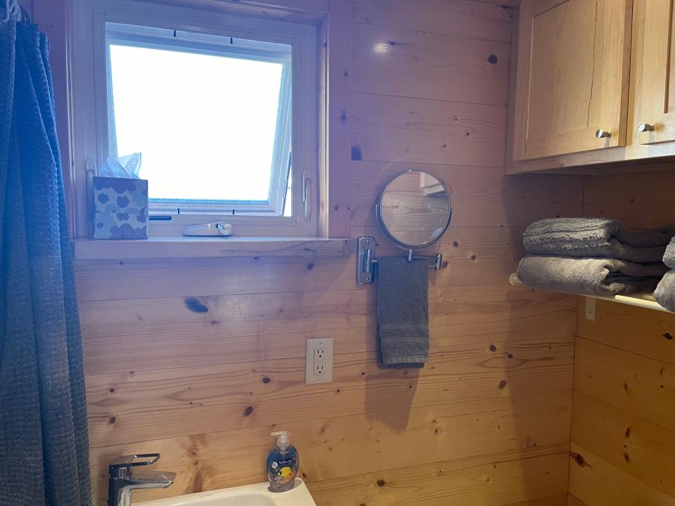 window, mirror, and storage in bathroom of tiny home airbnb near disneyland