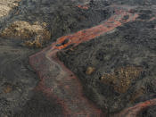 Lava flows from a volcano in Grindavik, Iceland, Wednesday, May 29, 2024. A volcano in southwestern Iceland erupted Wednesday for the fifth time since December, spewing red lava that once again threatened the coastal town of Grindavik and led to the evacuation of the popular Blue Lagoon geothermal spa. (AP Photo/Marco di Marco)