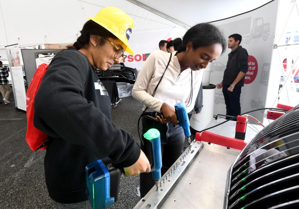 Oct 13, 2022; Tuscaloosa, AL, USA; Northridge High students Shresta Majeti and Rhyana Mahatsente use power drills to drive bolts in place at part of the Mercedes-Benz display during the West Alabama Works Worlds of Work expo at Shelton State.