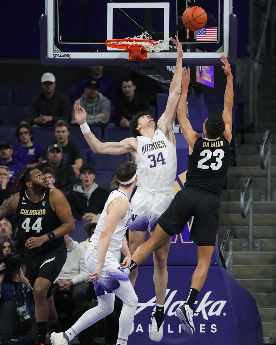Colorado forward Tristan da Silva (23) makes a basket while being fouled by Washington center Braxton Meah (34) during the first half of an NCAA college basketball game Wednesday, Jan. 24, 2024, in Seattle. (AP Photo/Lindsey Wasson)