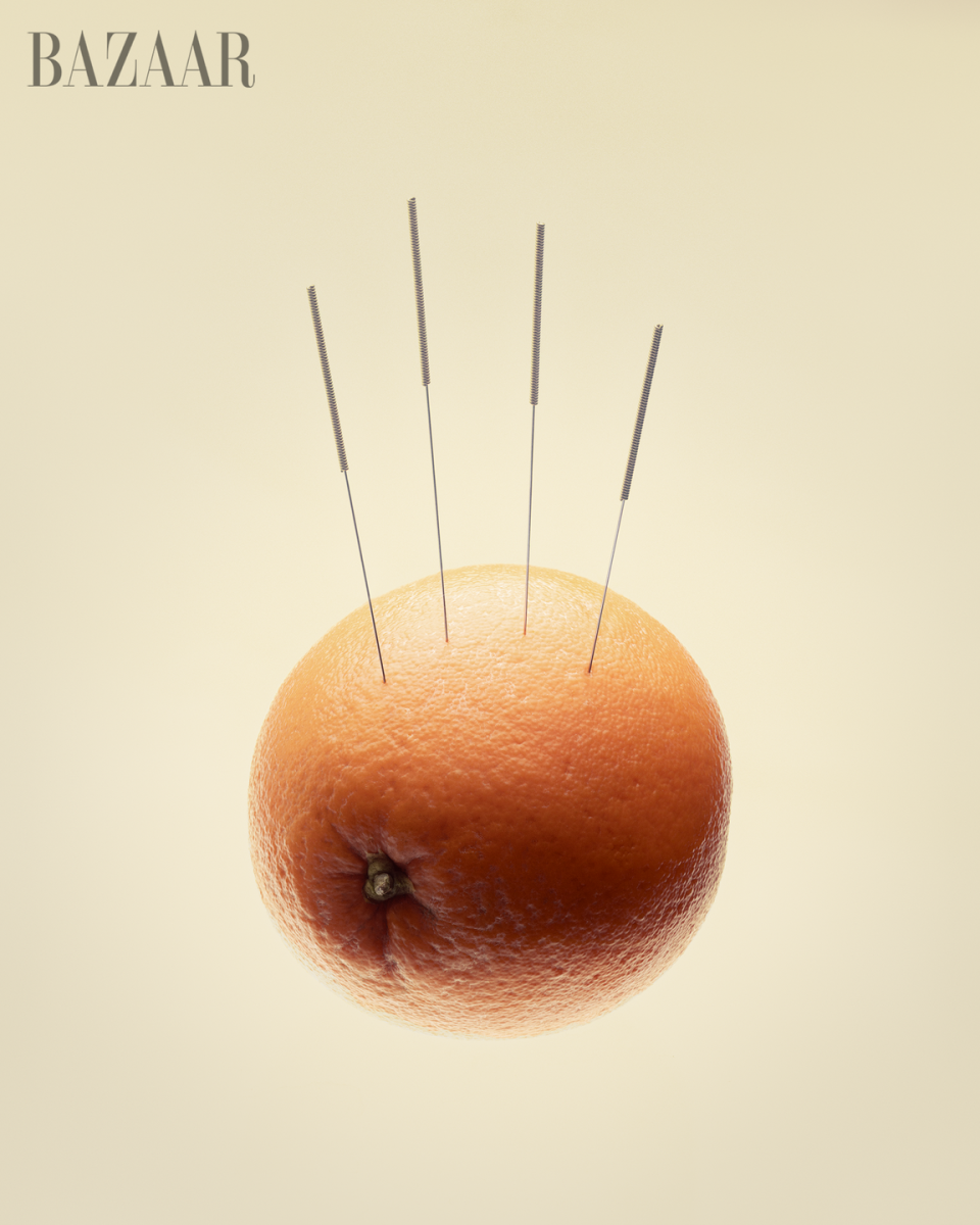 orange with acupuncture needles spa relaxation