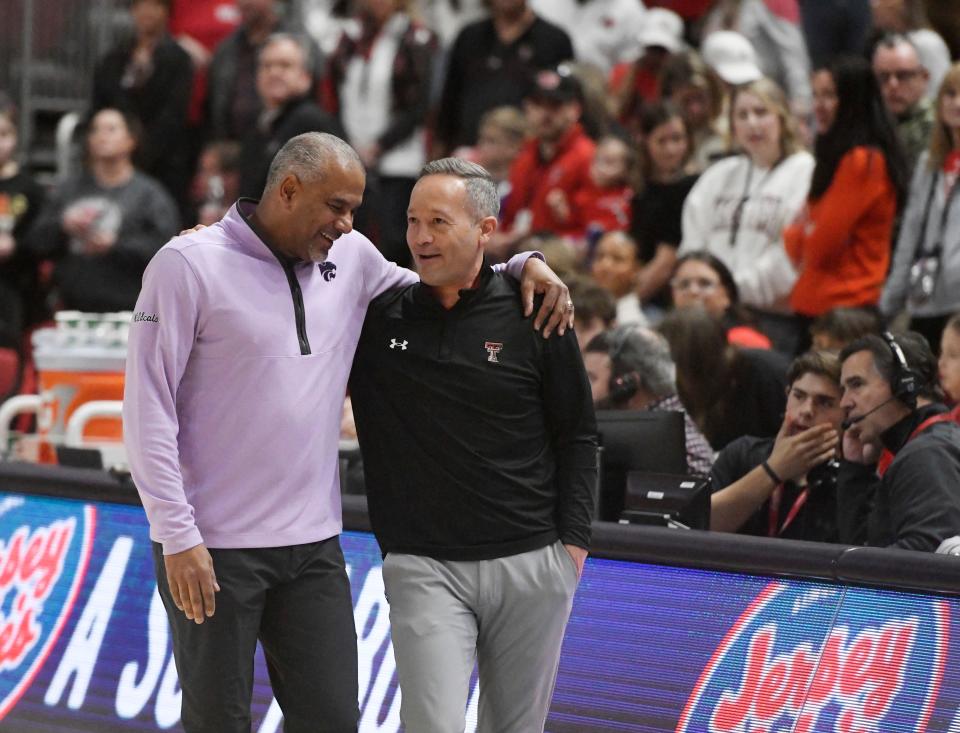 Kansas State coach Jerome Tang, left, and Texas Tech coach Grant McCasland embrace before Saturday's game at United Supermarkets Arena. in Lubbock, Texas. The two head coaches were assistants together at Baylor for five years.
