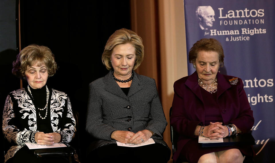 WASHINGTON, DC - DECEMBER 06:  Former U.S. Secretary of State Hillary Clinton (C), former U.S. Secretary of State Madeleine Albright (R), and Annette Lantos bow their heads during a moment of silence for former South African President Nelson Mandela before Clinton was presented the 2013 Tom Lantos Human Rights Prize December 6, 2013 in Washington, DC. Clinton received the award for her work in the areas of women's rights and internet freedom.  (Photo by Win McNamee/Getty Images)