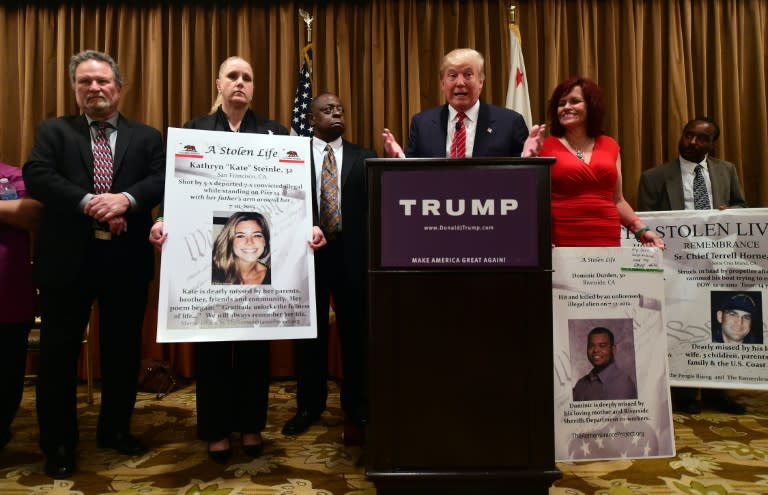 Donald Trump speaks while surrounded by people who's families were victims of illegal immigrants while meeting with the press at the Beverly Wilshire Hotel in Beverly Hills, California, on July 10, 2015