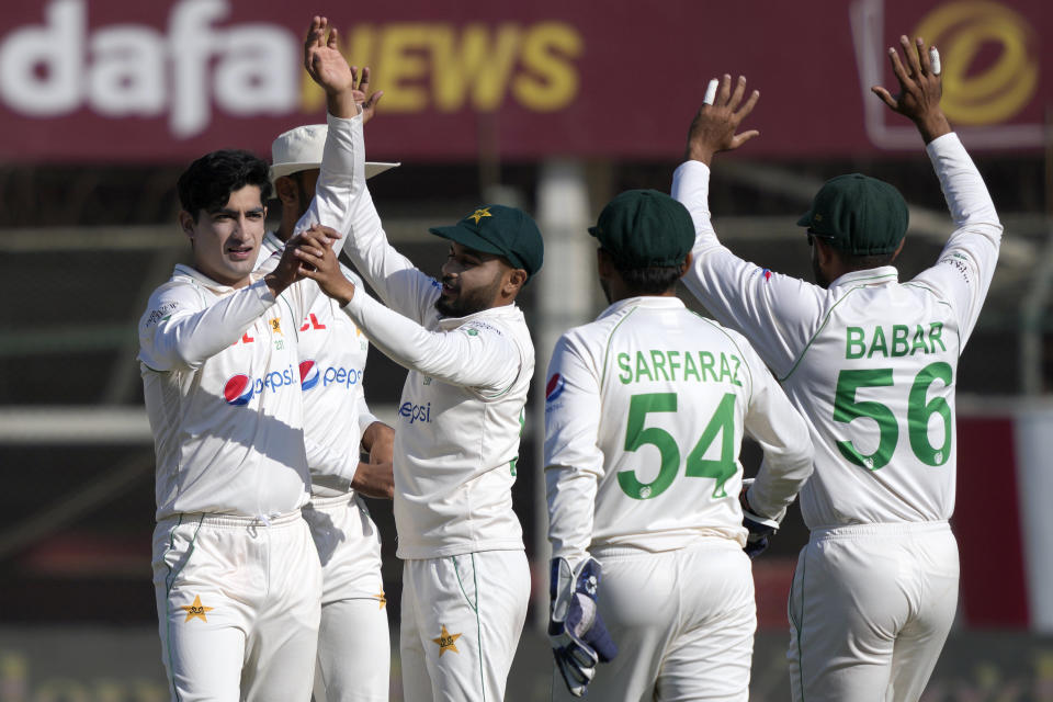 Pakistan's Naseem Shah, left, celebrates with teammates after taking the wicket of Zealand's Ish Sodhi during the second day of the second test cricket match between Pakistan and New Zealand, in Karachi, Pakistan, Tuesday, Jan. 3, 2023. (AP Photo/Fareed Khan)