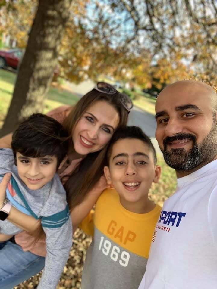 Zainab Al-Fatlawi and her husband, Sami, with their children in their yard in 2021 in Thompson Station, Tenn.