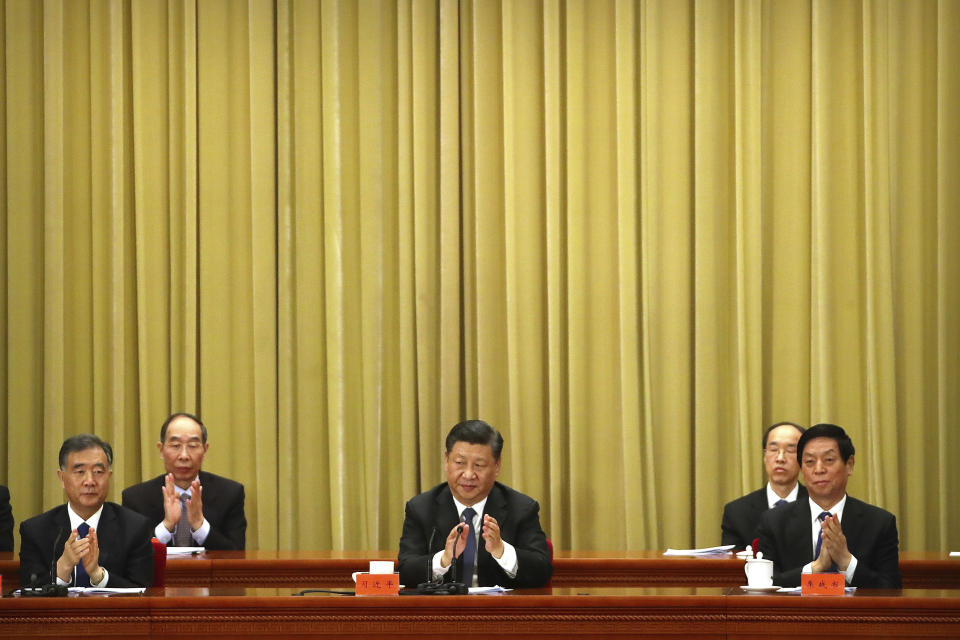 Chinese President Xi Jinping, center, applauds during an event to commemorate the 40th anniversary of the Message to Compatriots in Taiwan at the Great Hall of the People in Beijing, Wednesday, Jan. 2, 2019. Xi urged both sides to reach an early consensus on the unification of China and Taiwan and not leave the issue for future generations. (AP Photo/Mark Schiefelbein, Pool)