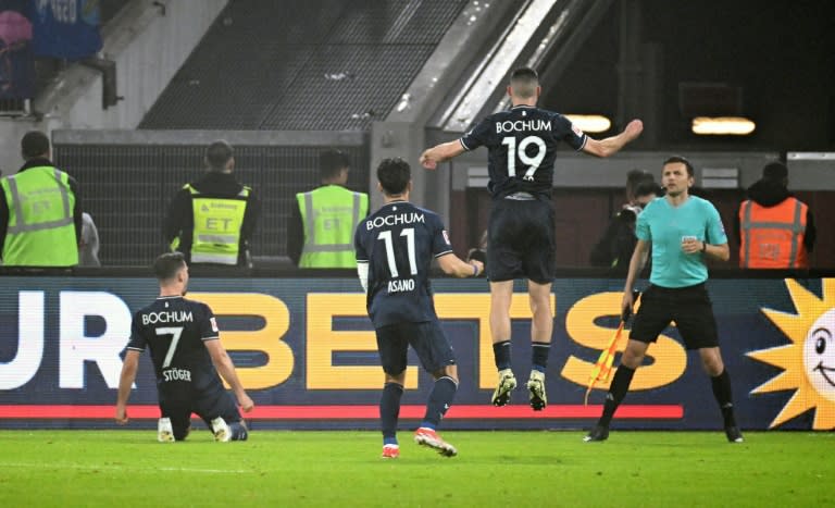Kevin Stoeger (L) scored one and set up two as Bochum beat Fortuna Duesseldorf on penalties to retain their place in the Bundesliga (UWE KRAFT)