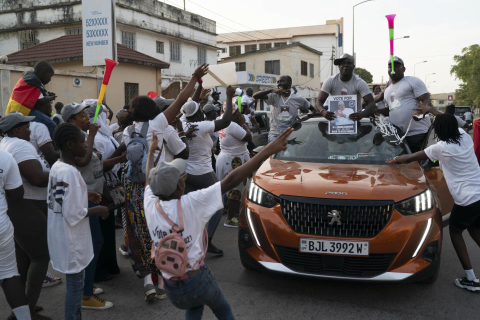 Supporters of the Gambian President Adama Barrow celebrate the partial results that give the lead to their candidate during the counting ballots in Gambia's presidential election, in Banjul, Gambia, Sunday, Dec. 5, 2021. Election officials in the West African nation of Gambia have started counting marble votes after polls closed for the first presidential election in decades that does not include former dictator Yahya Jammeh as a candidate. (AP Photo/Leo Correa)