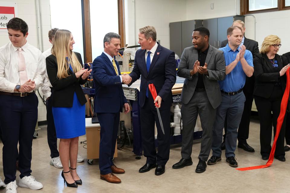 Lt. Gov. Jon Husted shakes hands with Johnstown-Monroe Schools Superintendent Philip Wagner after cutting a ceremonial ribbon during the Monday grand opening of the Johnstown-Monroe High School Innovation Lab sponsored by Meta.