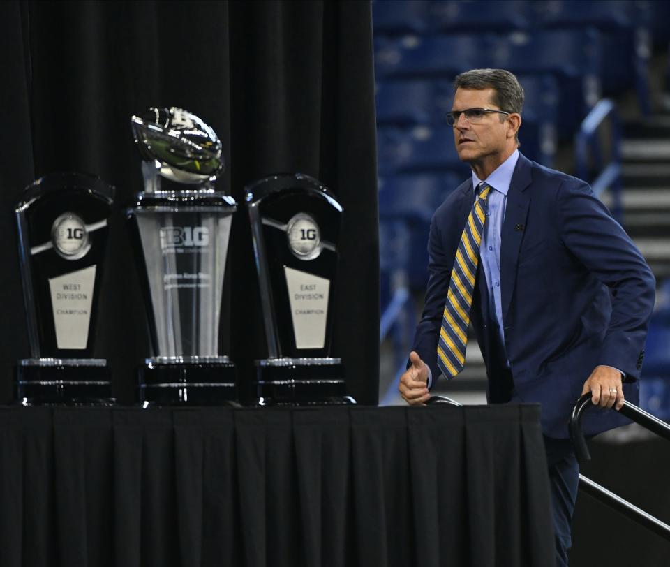 Jim Harbaugh as close to the Big Ten trophy as he's every been... physically, that is.