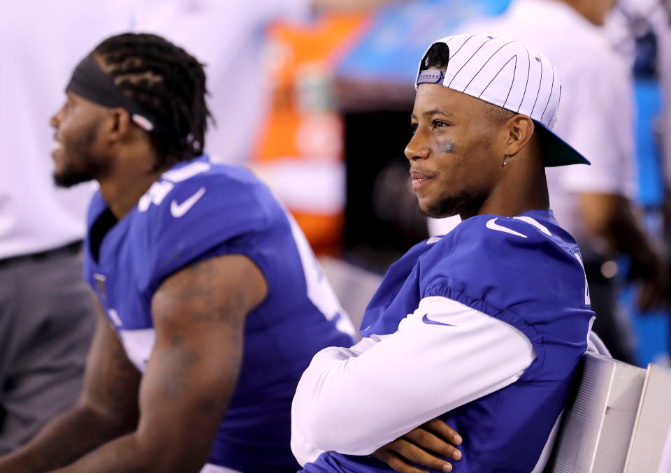 EAST RUTHERFORD, NEW JERSEY - AUGUST 16: Saquon Barkley #26 of the New York Giants looks on from the bench in the second half against the Chicago Bears during a preseason game at MetLife Stadium on August 16, 2019 in East Rutherford, New Jersey. (Photo by Elsa/Getty Images)