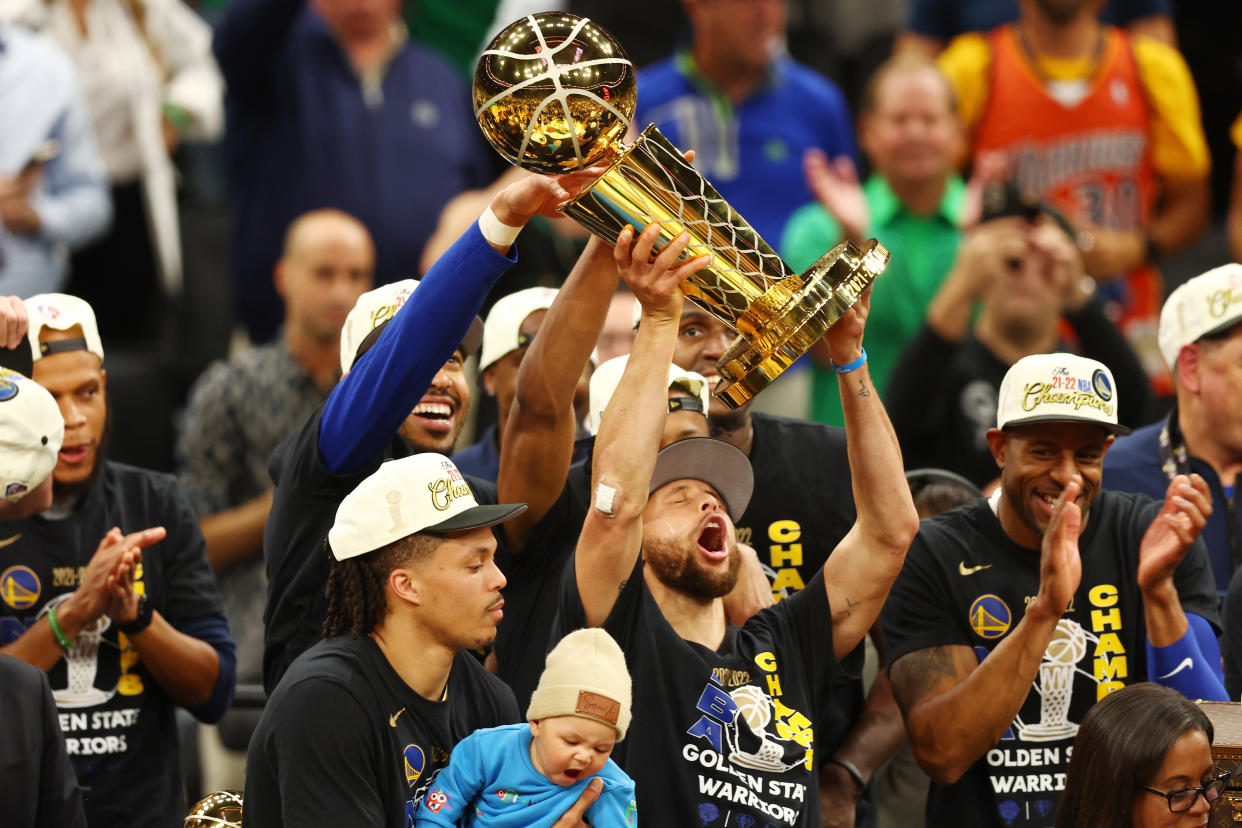 Stephen Curry raises the Larry O'Brien Trophy after the Golden State Warriors defeated the Boston Celtics in the 2022 NBA Finals in June. (Adam Glanzman/Getty Images)