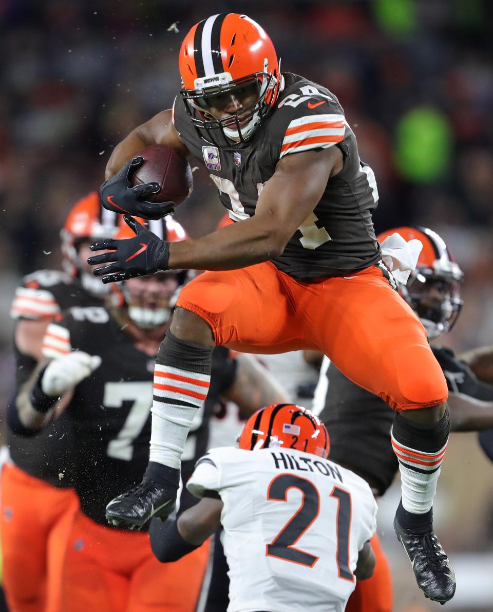 Browns running back Nick Chubb hurdles Bengals cornerback Mike Hilton as he rushes for a first-half first down Monday, Oct. 31, 2022, in Cleveland.