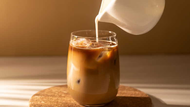 Pouring milk into coffee