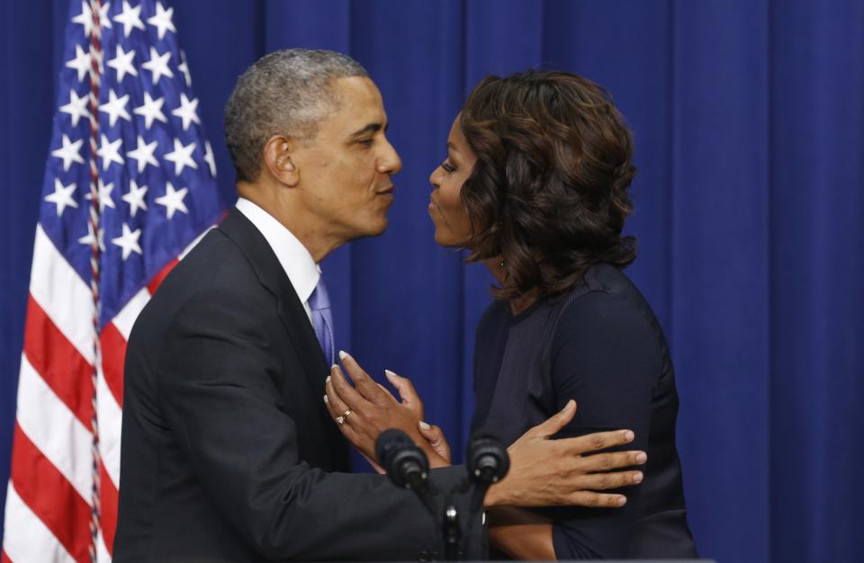 U.S. President Obama kisses first lady Michelle as he takes the stage to speak about college education at the White House in Washington